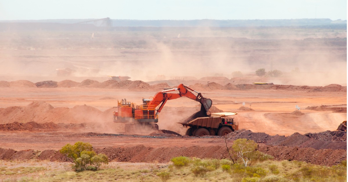 Excavating being undertaken on an iron ore mine site, creating potential dust hazards for workers and areas nearby.