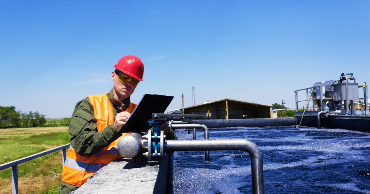 Man inspecting valve at water treatment plant